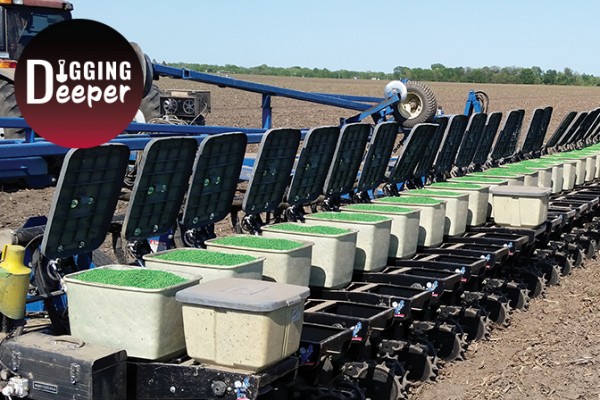 Photo of open and filled seed boxes in field on blue toolbar with red tractor with Digging Deeper logo