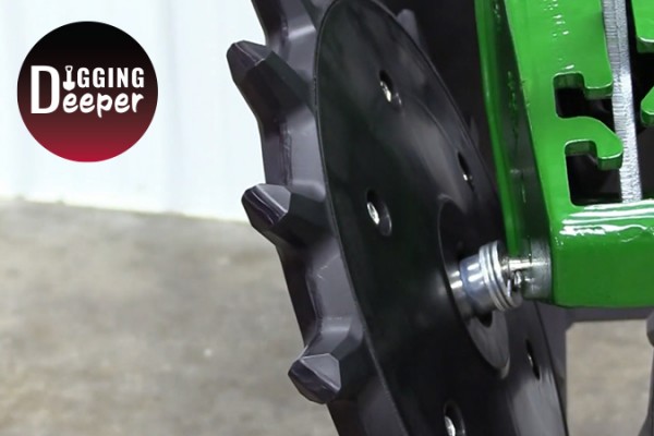 Closeup of Yetter Twister Closing Wheel being installed with Digging Deeper logo