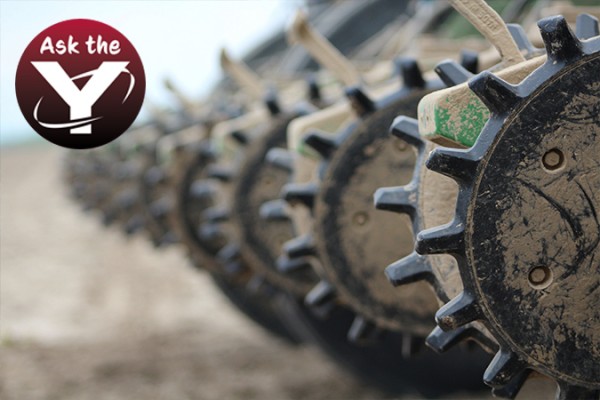 Closeup of Yetter Twister Cast Ring Closing Wheels in the field with Ask the Y logo